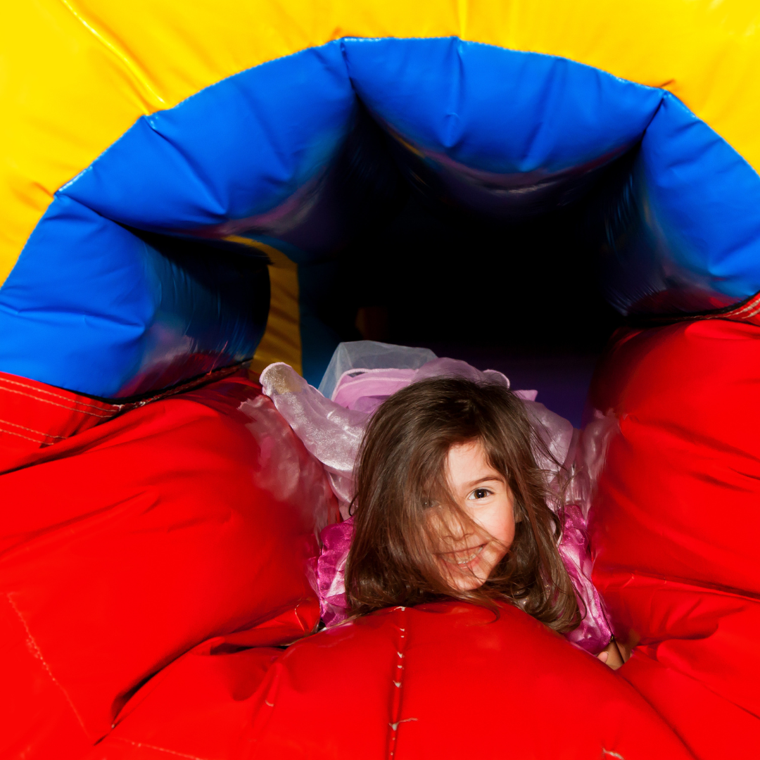 Kids enjoying inflatable rental at Dallas school event